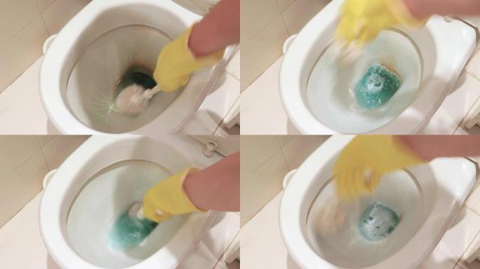 女人戴着黄色橡胶手套用刷子清洁肮脏的马桶。家政、洗涤和清洁浴室概念
