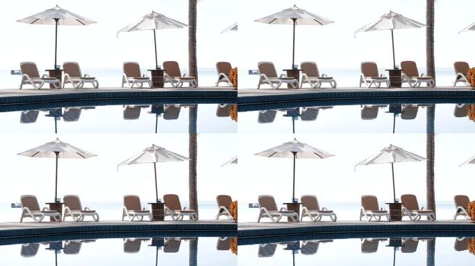 Beautiful umbrella and chair with swimming pool in