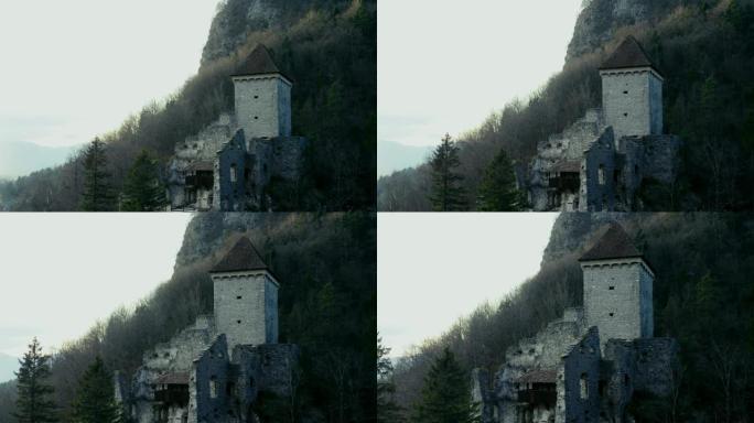 这座古老的中世纪城堡令人印象深刻的堡垒和断壁屹立在山下。