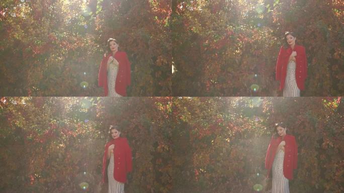 一个穿着裙子，穿着红色外套和秋天公园的漂亮女孩的肖像。