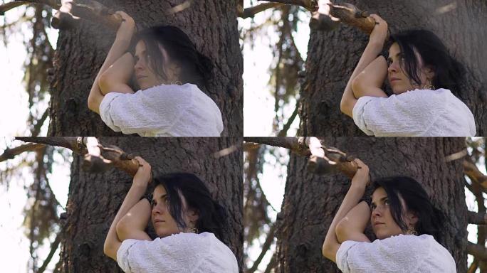 美丽的女人站在树旁仰望，爱上自然，漂亮的脸蛋
