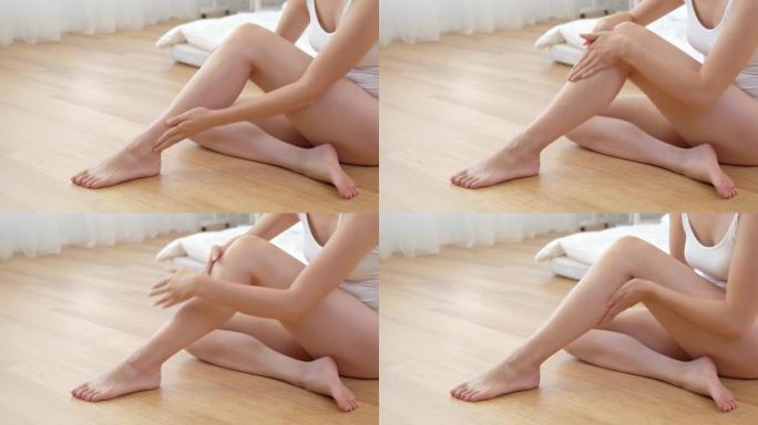 美丽的女人摸她的腿