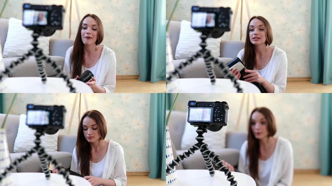 视频博客。女人博客在家里用相机拍摄