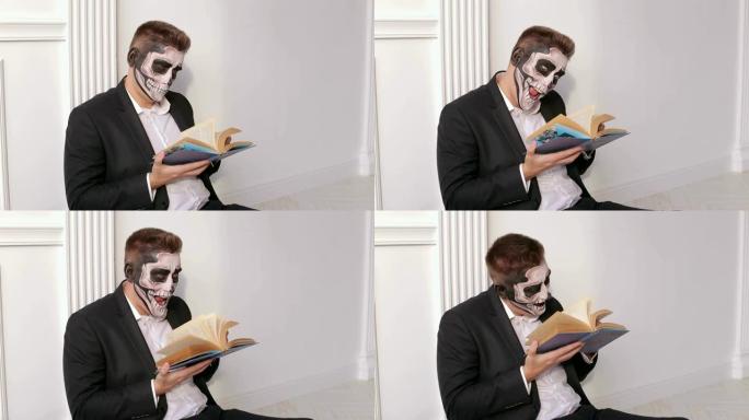 一个有着可怕的头骨化妆的男人手里拿着一本书。