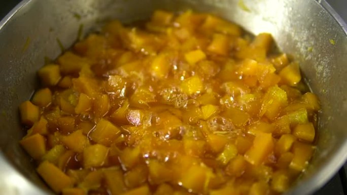 小片的甜南瓜菜在平底锅中煮沸并煮沸特写