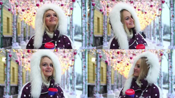 俄罗斯莫斯科。年轻漂亮的女孩正走在装饰精美的冬季街道上