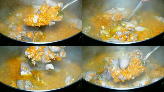烹饪自制食物。炖牛肉或浓汤鸡内脏和胡萝卜在平底锅中煮沸。