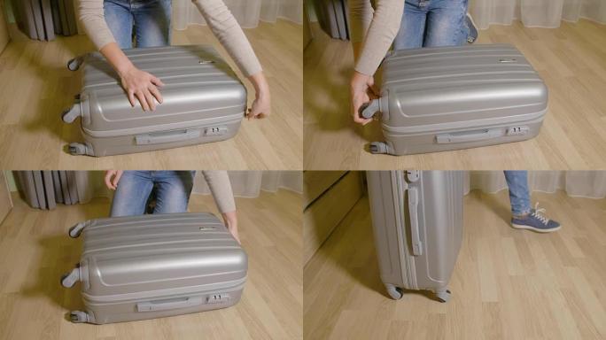 旅行箱上的女孩闭合拉链紧固件。拉拉链手提箱的女人