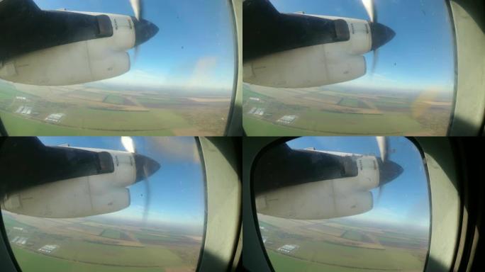 从带有旋转螺旋桨叶片的发动机上的轻型飞机的窗口看
