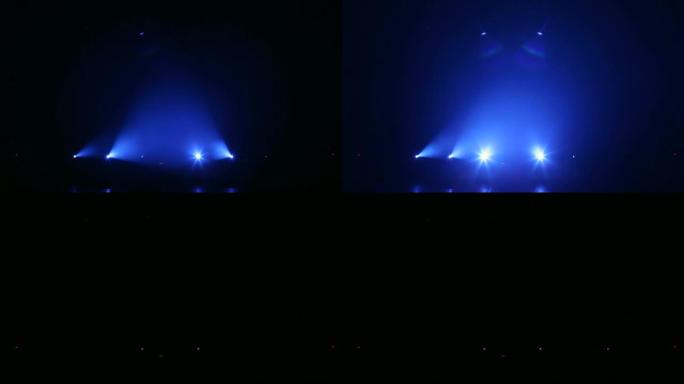 蓝色光线在黑暗中交替闪烁。空的音乐会舞台。
