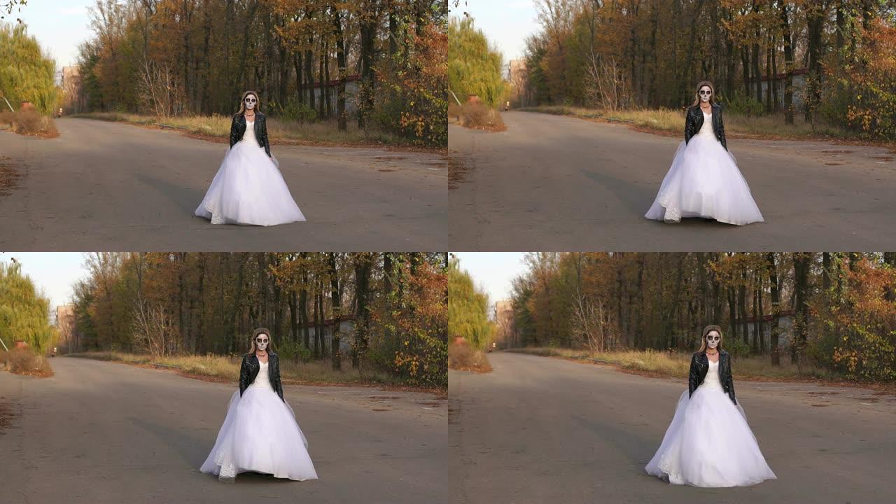 一个穿着婚纱的女孩在空荡荡的路上戴着骷髅面具。万圣节。