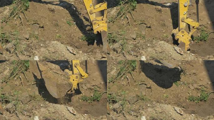 挖掘机在杯中装载土壤