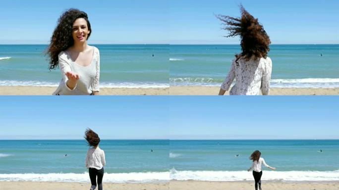 美丽卷发的年轻女子打着手势跟着我在沙滩上奔跑