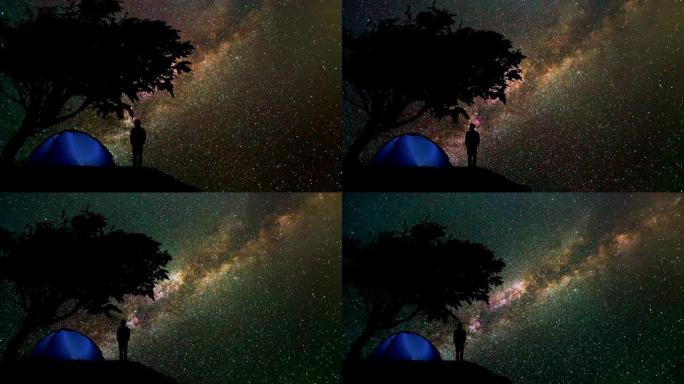 那个人站在山上，树在星空下。时间流逝