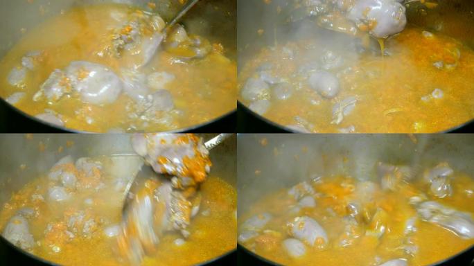 烹饪自制食物。炖牛肉或浓汤鸡内脏和胡萝卜在平底锅中煮沸。