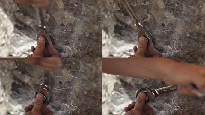 该名男子的手将钥匙螺栓拧入岩石的特写镜头。