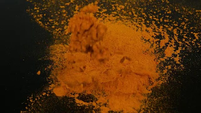 姜黄，姜黄，黑色背景下的粉末，印度香料，慢动作4K