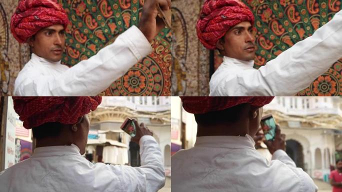 印度普什卡英俊的拉贾斯坦男子在手机摄像头上自拍