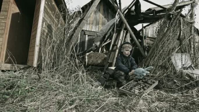 废墟上的一个无家可归的孩子。难民。