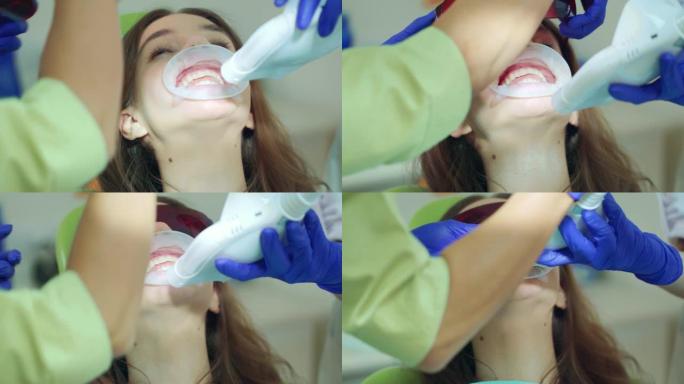 牙科诊所牙齿美白手术的患者。医生打开灯