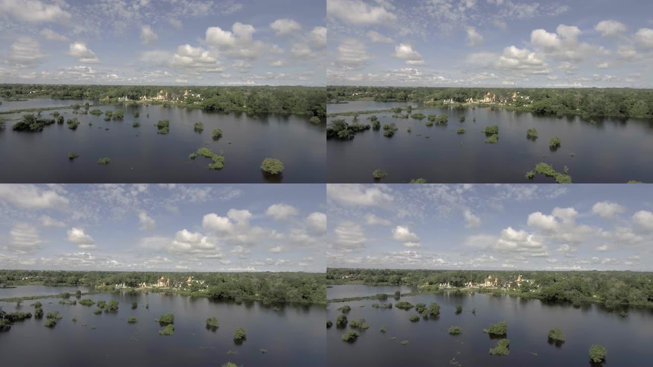 空中: 在农村地区的暴雨中飞越被洪水淹没的农田。宝塔为背景
