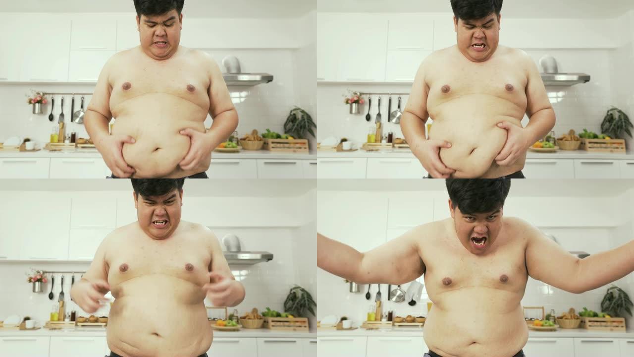 前视图: 泰国超重男子在大肚子上感到焦虑