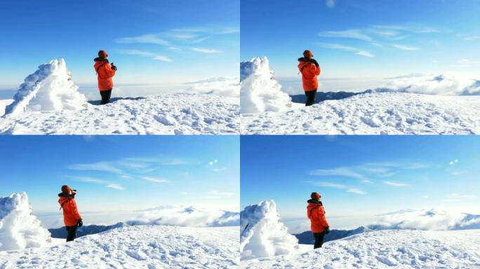 女性高山登山者在冬季日出时在高海拔山峰上喝咖啡