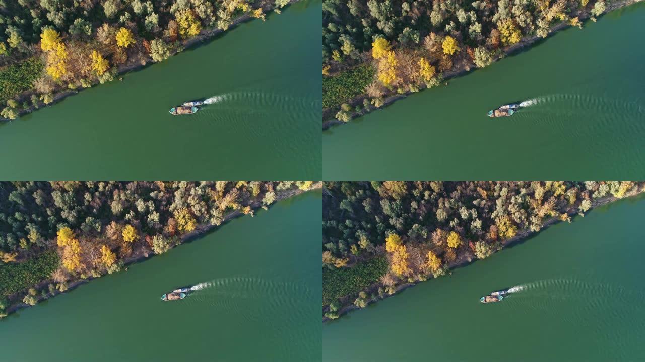 工业小船飘入多瑙河，海岸秋色彩树
