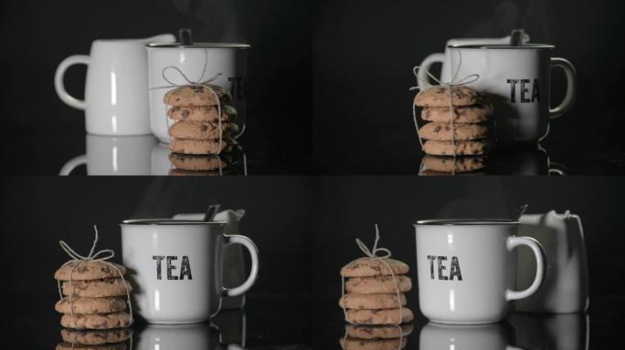 布列塔尼礼品饼干和一杯黑色背景的茶，蒸汽。