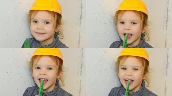 女孩，戴着黄色头盔的孩子，用钳子撕掉牙齿