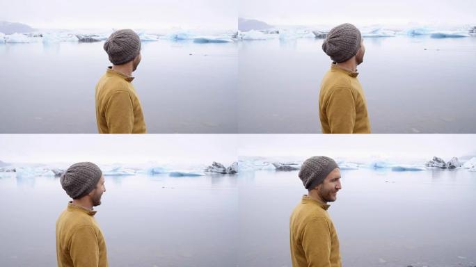 观光客男性看冰川泻湖享受北欧自然旅游人概念