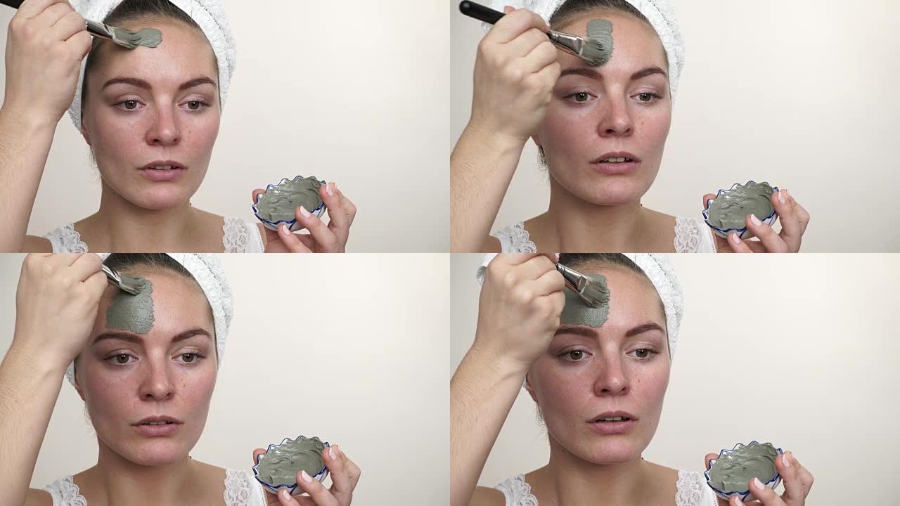 女人用刷子涂泥面膜涂在脸上4K