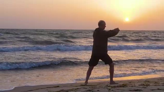 运动男子早上在海滩上练习武术时推手