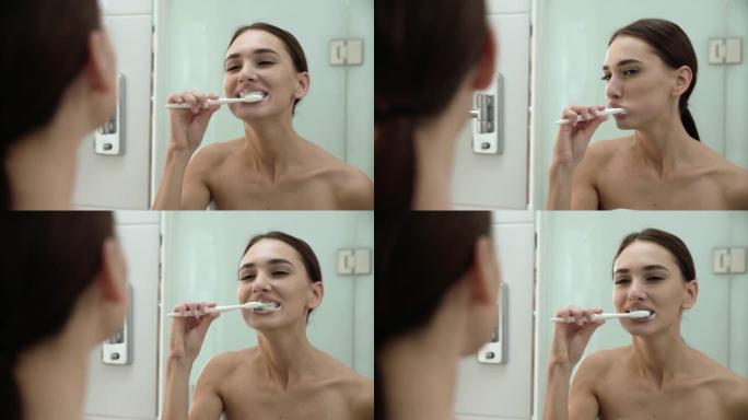 牙齿健康。女人在浴室刷牙