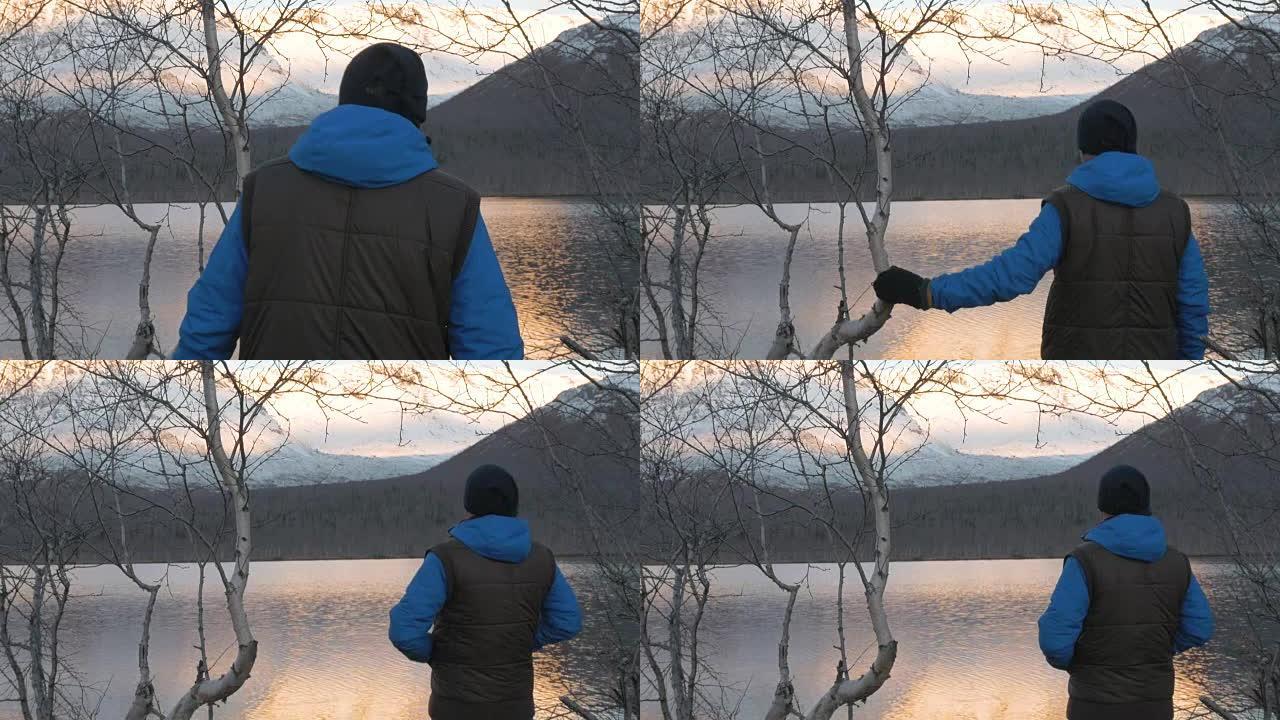 一个男人，一个中年运动员，在山里遇见黎明。他欣赏太阳和湖中群山的倒影。