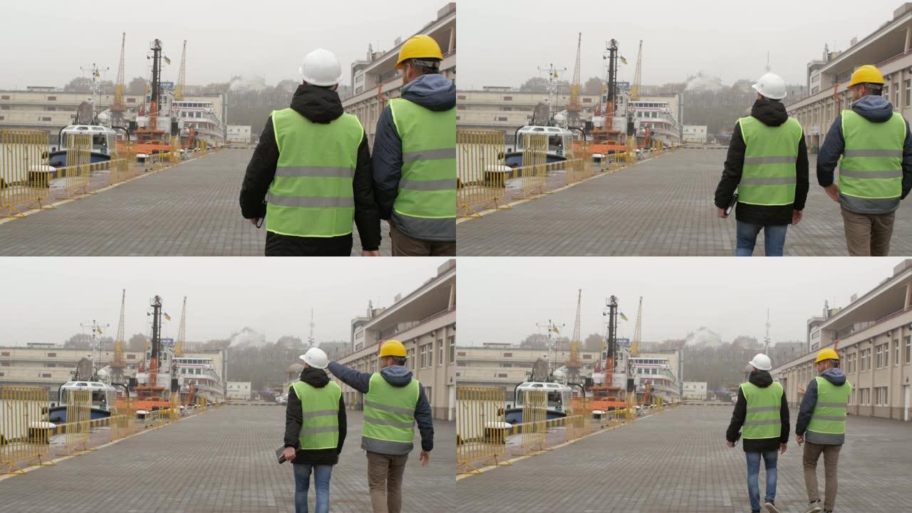 戴着头盔的港口工人去港口聊天