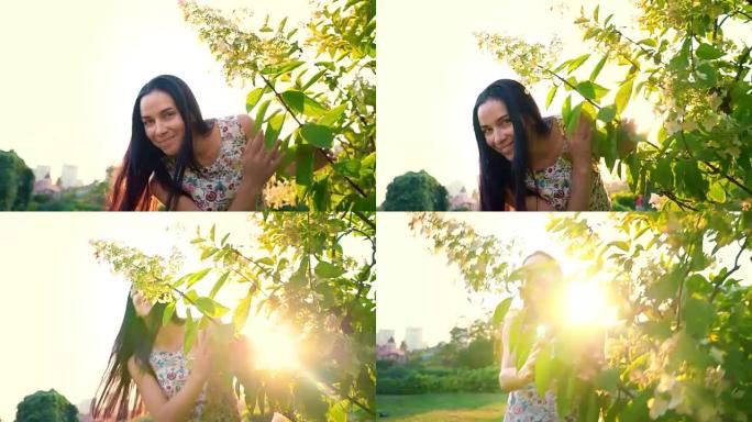 年轻女子在花园里嬉戏地绕着一棵绿树奔跑。一个微笑的黑发女人的肖像，脸颊凹陷，靠在绿色公园上。