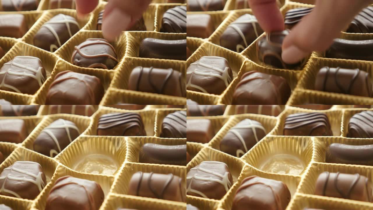 女性从多种不同的糖果中挑选一种背景4K 2160p 30fps超高清镜头-从各种巧克力礼品盒中选择3