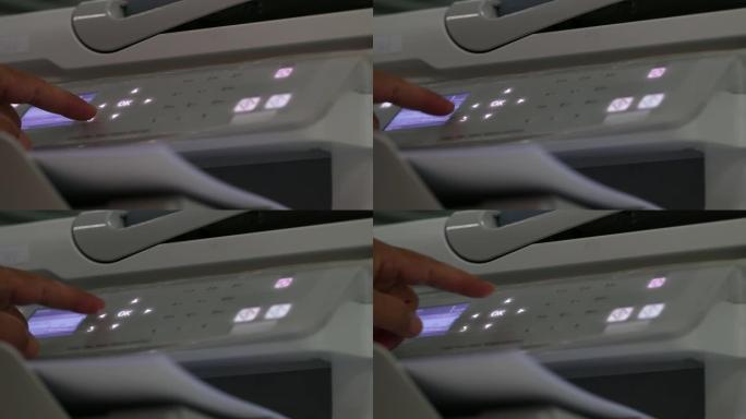 商业文件概念: 在繁忙的办公桌办公室，商人手在激光打印机中加工纸张。软聚焦