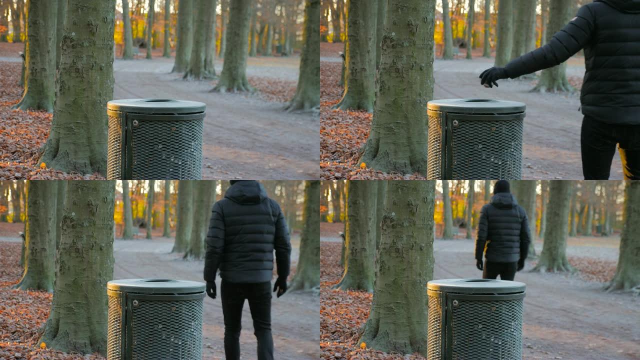 男子在公园的垃圾桶里扔垃圾