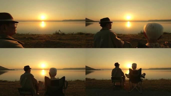 高级夫妇在湖边欣赏日落美景，慢动作