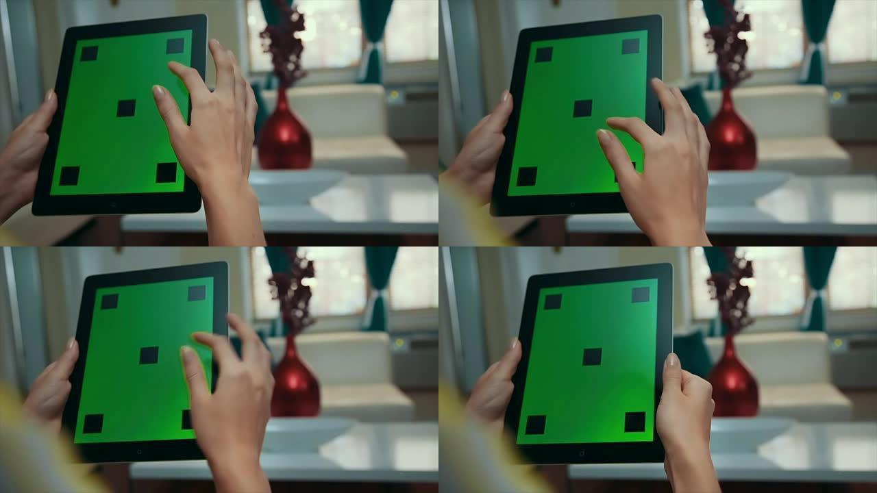 女人滚动并点击绿屏平板电脑