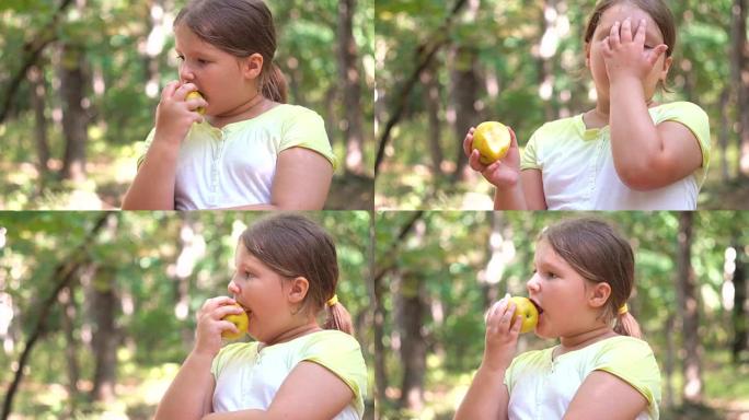 小女孩肖像在夏日吃苹果户外苹果