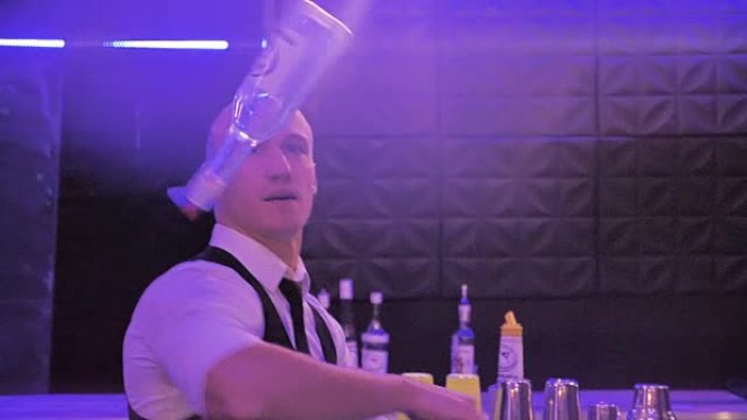 调酒师玩杂耍的瓶子，这名男子正在慢动作中展示令人印象深刻的表演