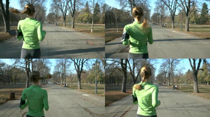 在公园小巷上奔跑的年轻女子