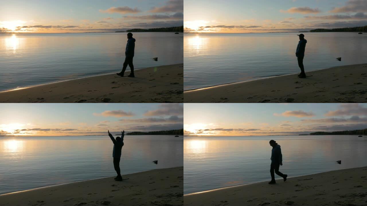 一个人在美丽的湖畔遇见黎明。他欣赏风景。