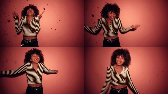 漂亮的非洲卷发黑人女孩在潘通背景上跳舞她最喜欢的歌曲。4k镜头-视频