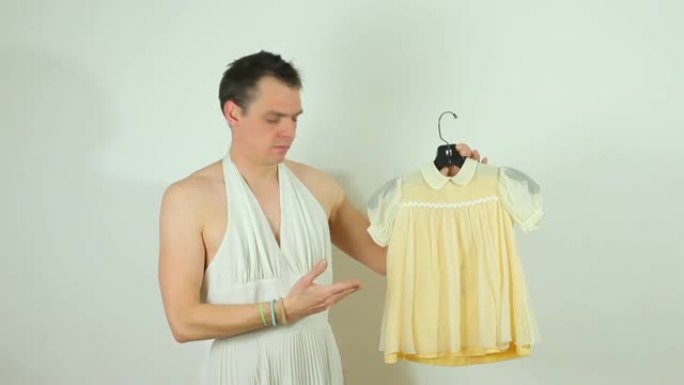 穿着白色连衣裙的家伙正在展示婴儿连衣裙