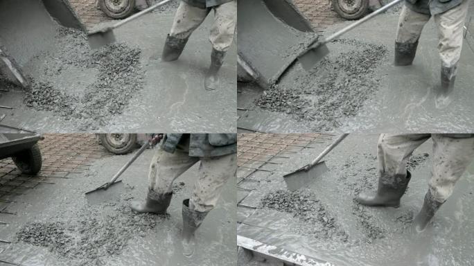 在农村道路上浇筑水泥的建筑工人的特写