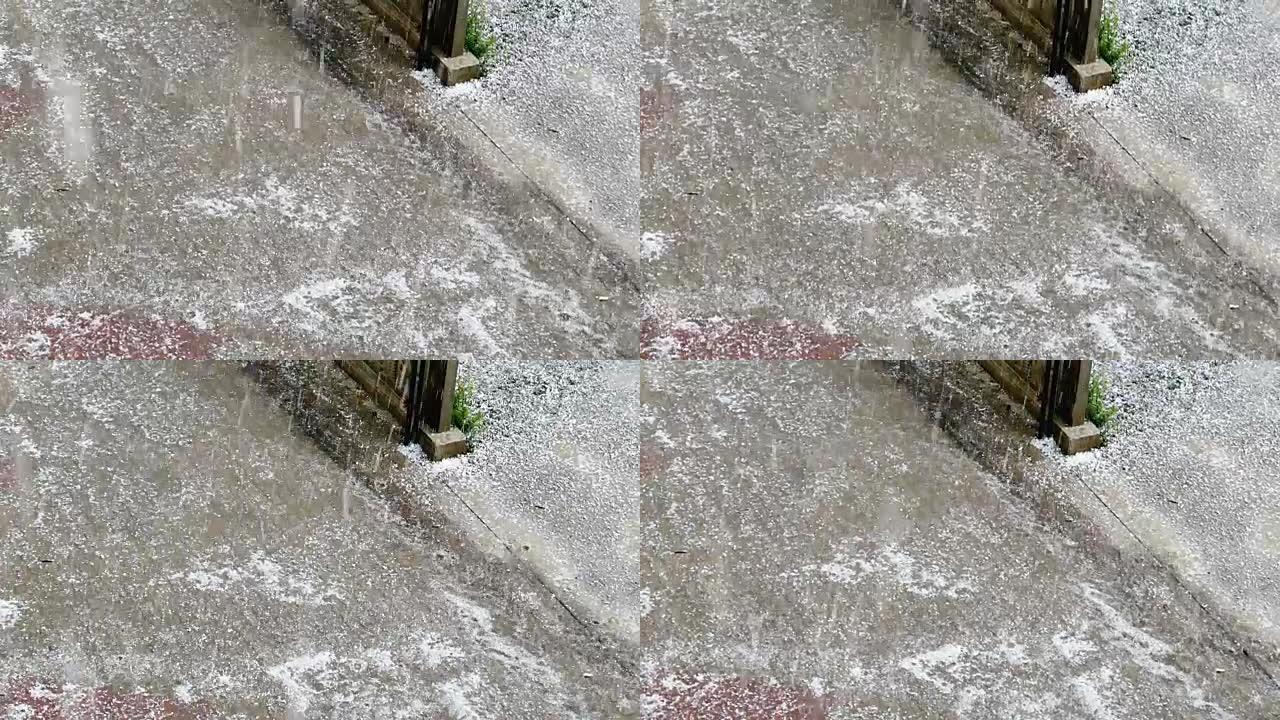 夏季雷暴时冰雹落下的地面视图。慢动作冰雹，冰雹落到阳台上，